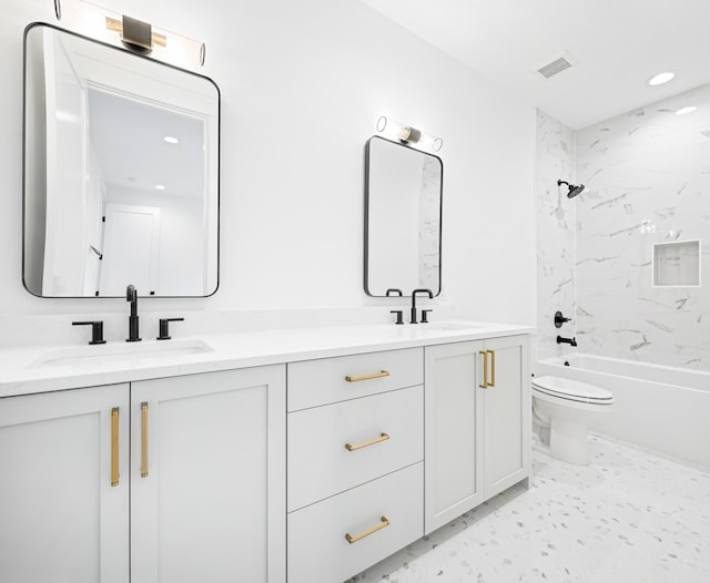 full bathroom with vanity, toilet, and tiled shower / bath