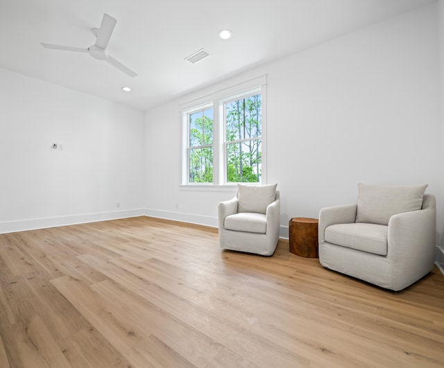 sitting room featuring light hardwood / wood-style floors and ceiling fan