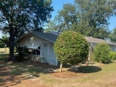 view of property exterior with a lawn