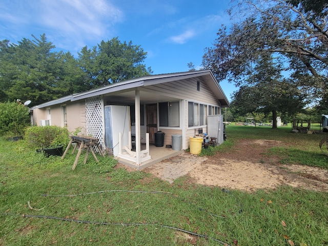 rear view of property with a yard