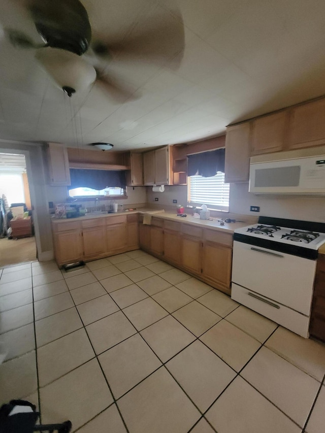 kitchen featuring light tile patterned flooring, white appliances, sink, and light brown cabinets