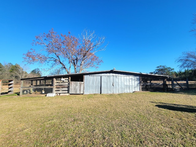 view of outbuilding with a lawn