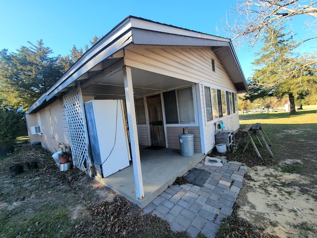 view of side of home with cooling unit and a patio