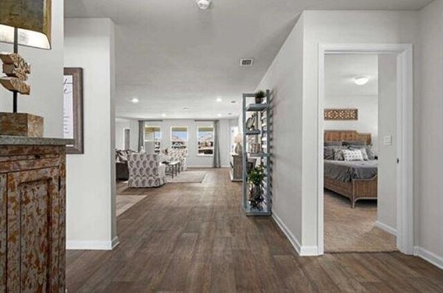 hall with baseboards, dark wood finished floors, and recessed lighting