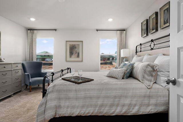 carpeted bedroom with multiple windows and recessed lighting