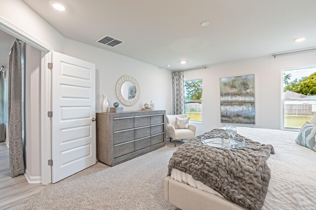 bedroom with recessed lighting, visible vents, and light carpet