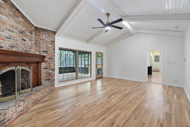 unfurnished living room featuring lofted ceiling with beams, a brick fireplace, light hardwood / wood-style floors, and ceiling fan