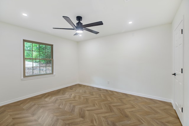 empty room with ceiling fan and light parquet floors