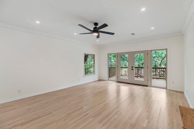 spare room with crown molding, light hardwood / wood-style floors, ceiling fan, and french doors