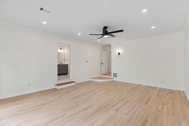 unfurnished living room featuring light hardwood / wood-style flooring, ceiling fan, and crown molding