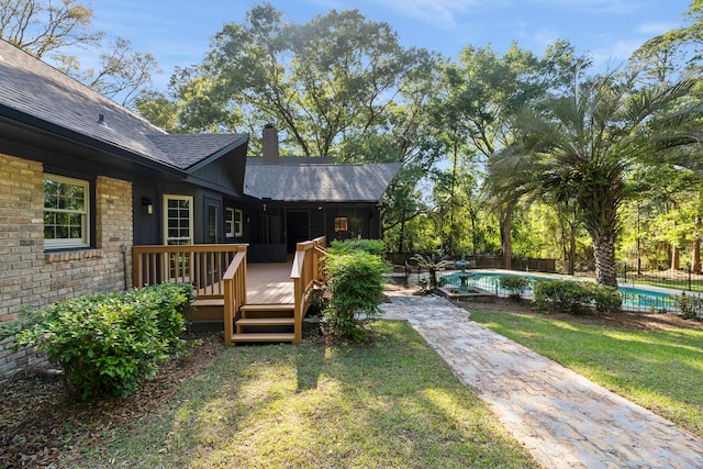 view of yard with a swimming pool side deck