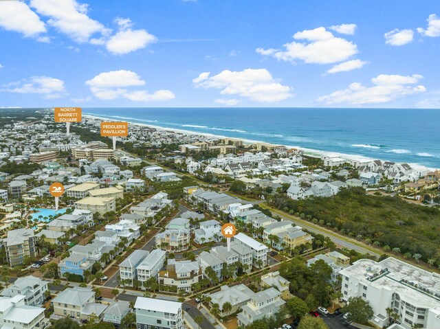 bird's eye view with a water view and a beach view