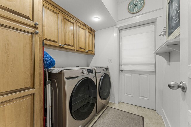 laundry area with washer and dryer, cabinet space, baseboards, and light tile patterned floors