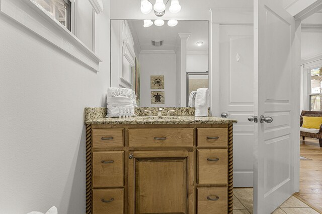 bathroom with ornamental molding, vanity, visible vents, and tile patterned floors