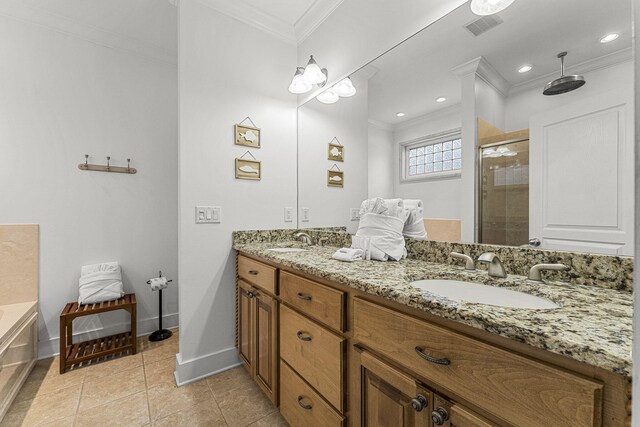 full bath with a stall shower, crown molding, visible vents, and a sink