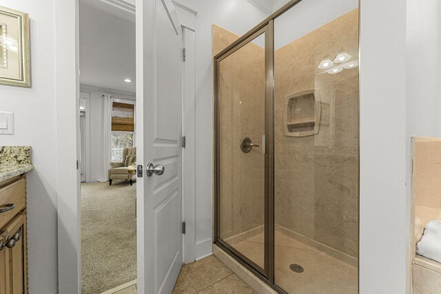 full bathroom with tile patterned flooring, a shower stall, and vanity