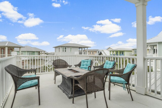 view of patio with a residential view and an outdoor living space with a fire pit