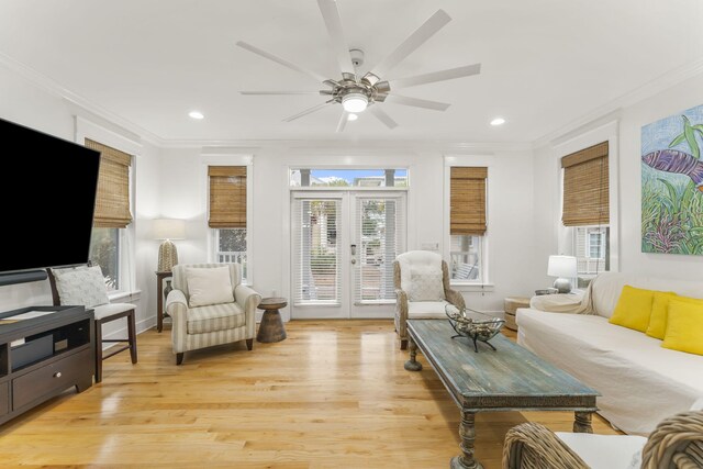 living area with recessed lighting, light wood-style flooring, crown molding, and french doors