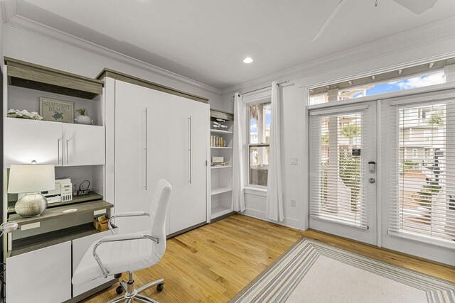 home office with light wood-style flooring, recessed lighting, french doors, built in study area, and crown molding