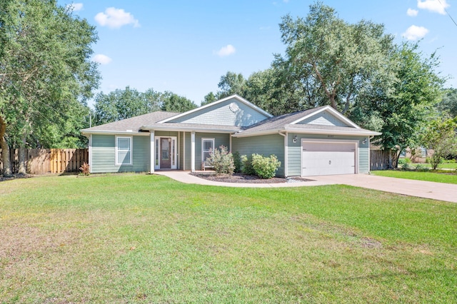 ranch-style home with a garage and a front lawn