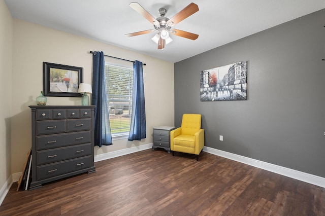 living area featuring ceiling fan and dark hardwood / wood-style floors