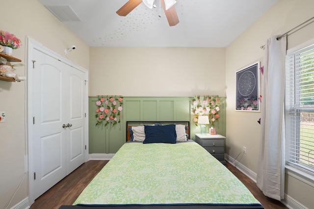 bedroom featuring a closet, ceiling fan, and dark hardwood / wood-style floors