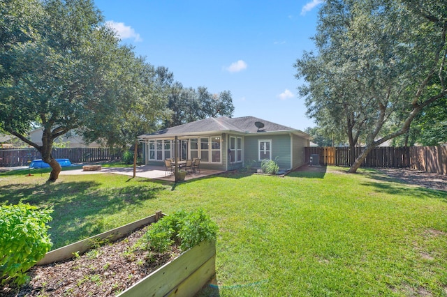 back of house with a sunroom, a yard, and a patio area