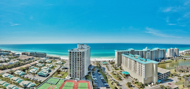 birds eye view of property with a water view and a beach view