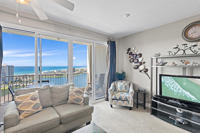 carpeted living room with a textured ceiling and ceiling fan