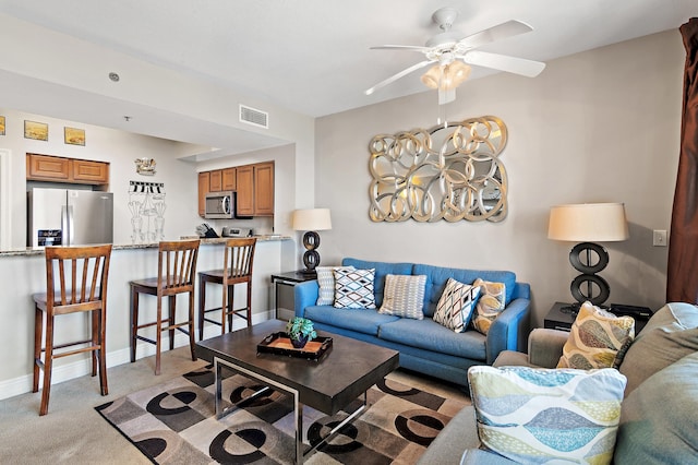 living room with light colored carpet and ceiling fan