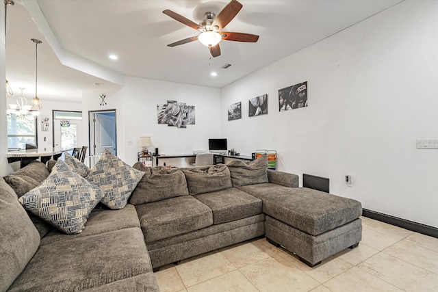 living room featuring ceiling fan with notable chandelier and light tile patterned floors