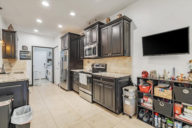 kitchen featuring sink, light tile patterned floors, stainless steel appliances, and tasteful backsplash