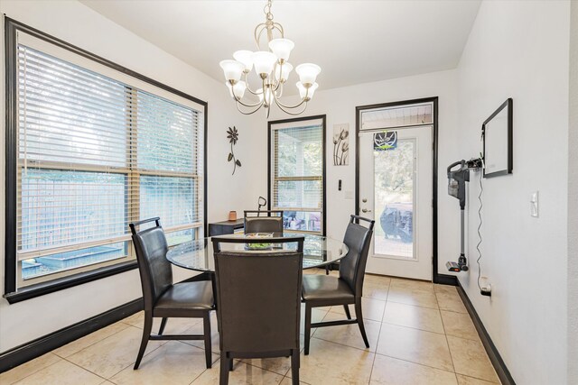 tiled dining room with a notable chandelier and plenty of natural light