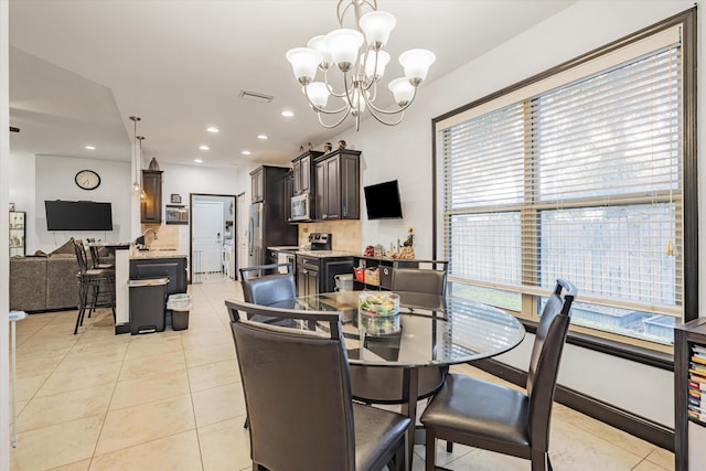 dining room featuring light tile patterned flooring, a chandelier, and a wealth of natural light