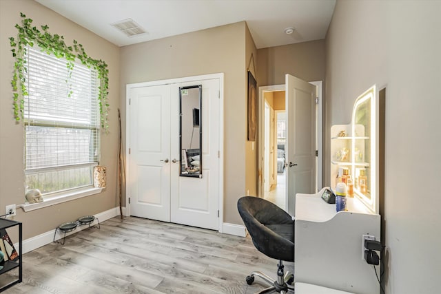 home office with light hardwood / wood-style floors