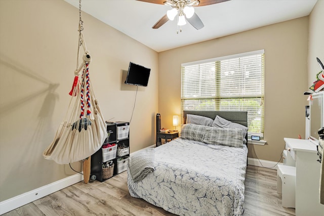 bedroom with ceiling fan and light hardwood / wood-style floors