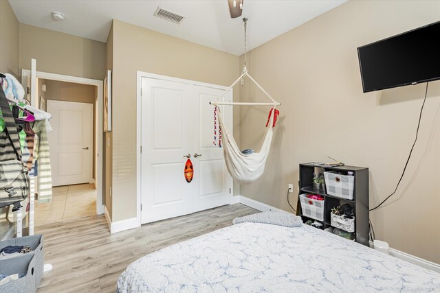 bedroom with wood-type flooring and ceiling fan