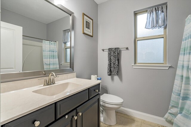 bathroom featuring curtained shower, tile patterned flooring, vanity, and toilet