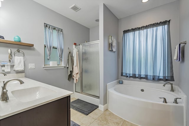 bathroom featuring vanity, shower with separate bathtub, and tile patterned floors