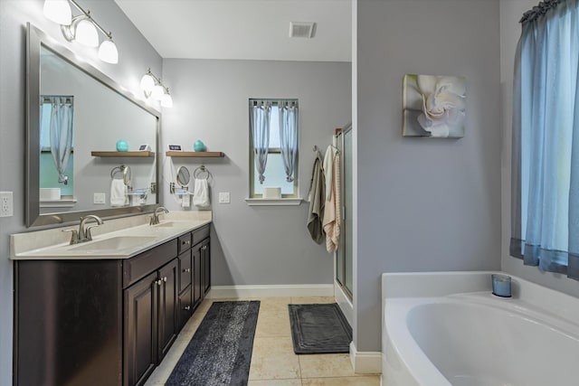 bathroom featuring shower with separate bathtub, tile patterned floors, and vanity