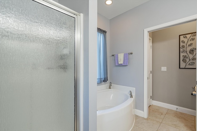 bathroom with independent shower and bath and tile patterned floors