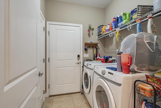 laundry room with washer and clothes dryer and light tile patterned floors