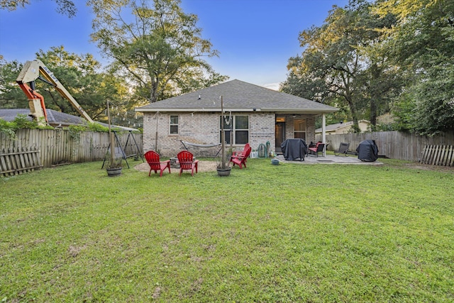 back of property with a patio and a yard