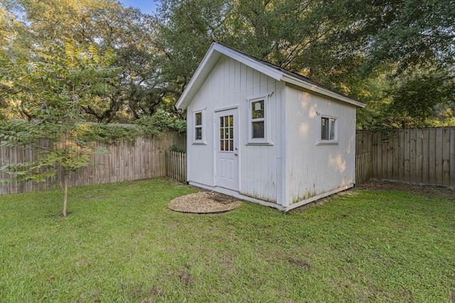 view of outbuilding featuring a lawn