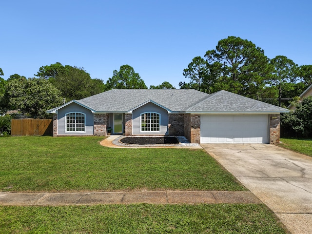 single story home featuring a garage and a front lawn