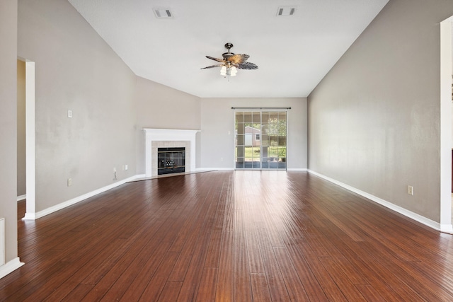 unfurnished living room featuring ceiling fan, vaulted ceiling, a fireplace, and dark hardwood / wood-style flooring