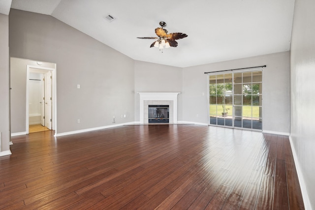 unfurnished living room featuring lofted ceiling, a fireplace, ceiling fan, and dark wood-type flooring