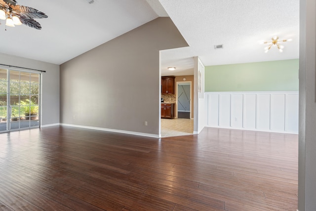 unfurnished room with a textured ceiling, light hardwood / wood-style floors, lofted ceiling, and ceiling fan