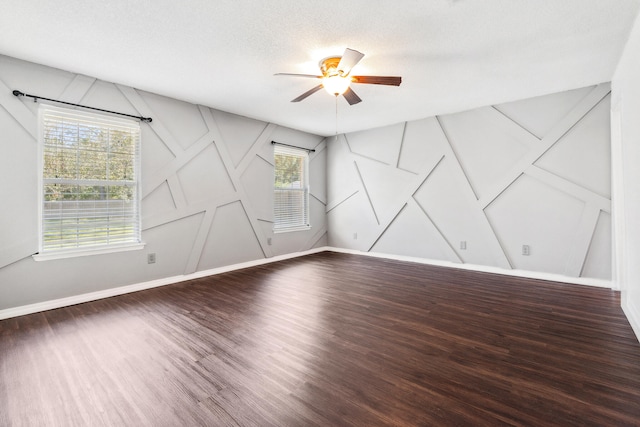 unfurnished room featuring ceiling fan, hardwood / wood-style floors, and a textured ceiling