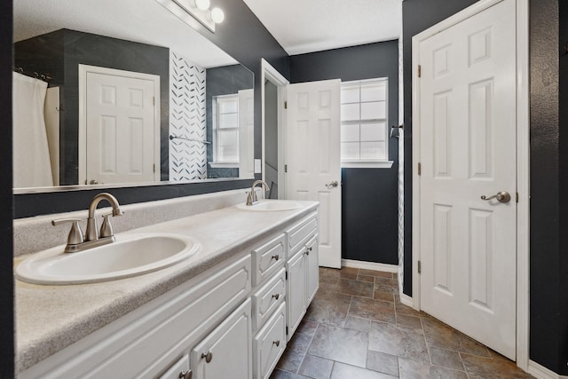 bathroom featuring plenty of natural light and vanity